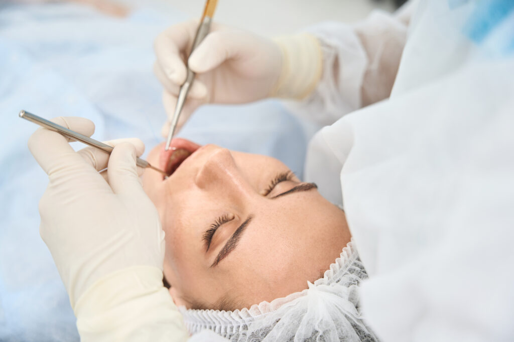 patient lying down in the dental chair with the dentist performing a procedure