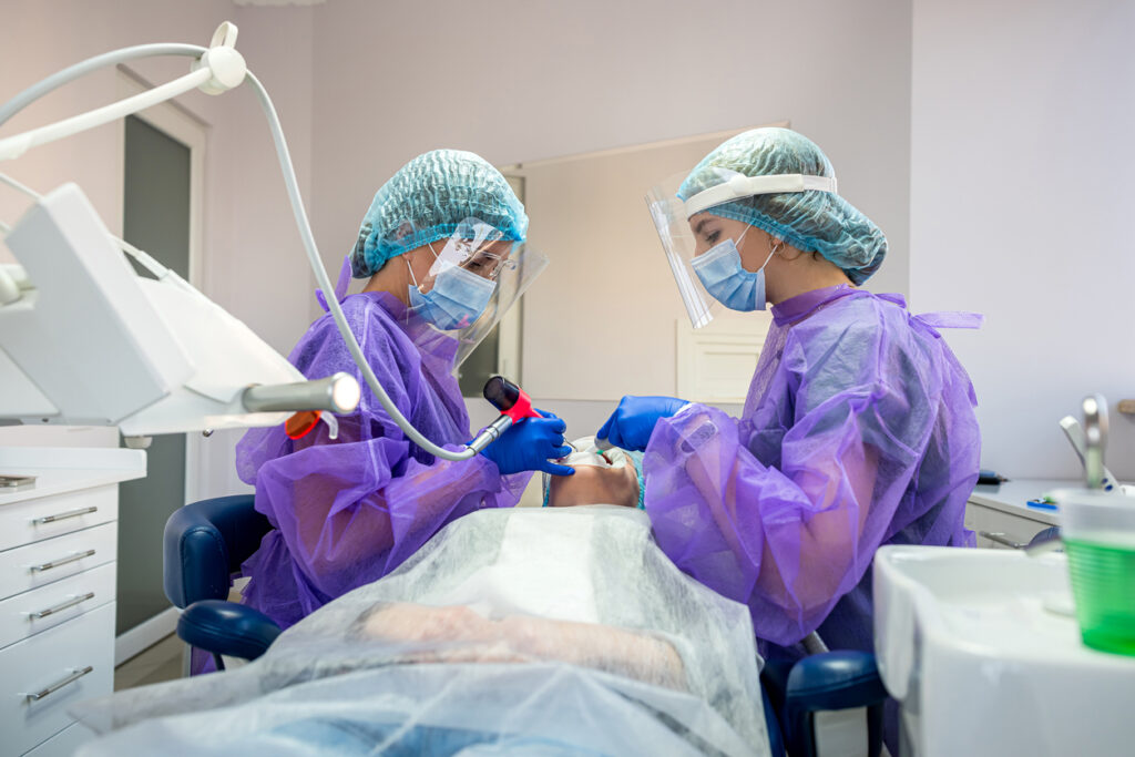 Dentists performing a dental extraction