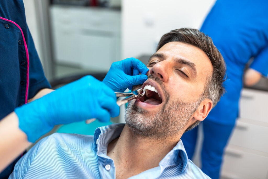 Dental patient undergoing a safe tooth extraction