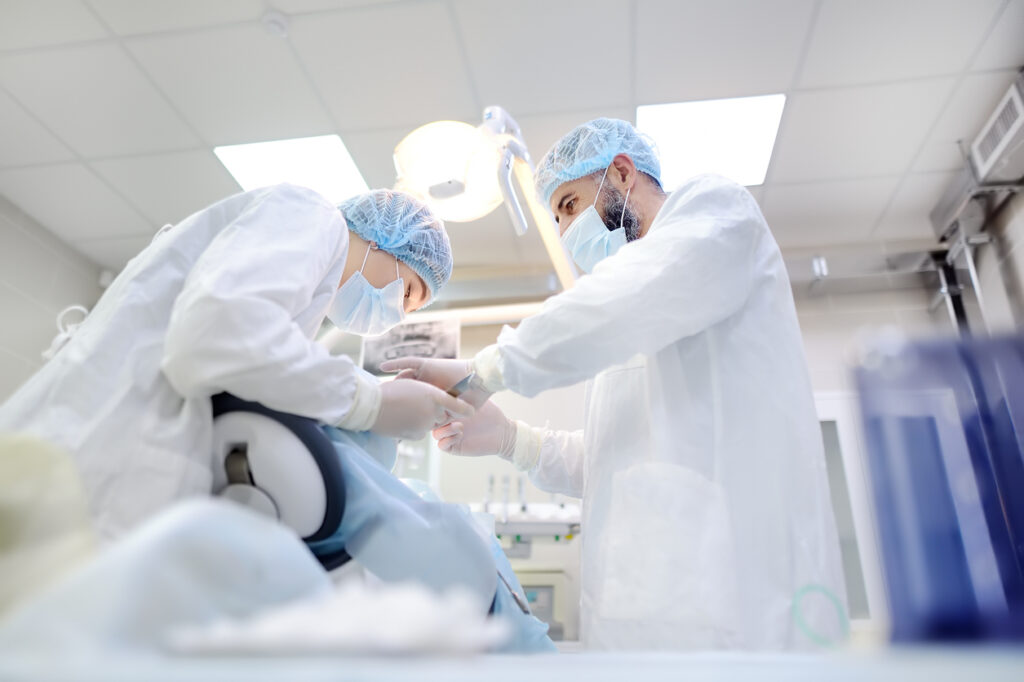 Dentist performing a dental procedure while the patient is sedated