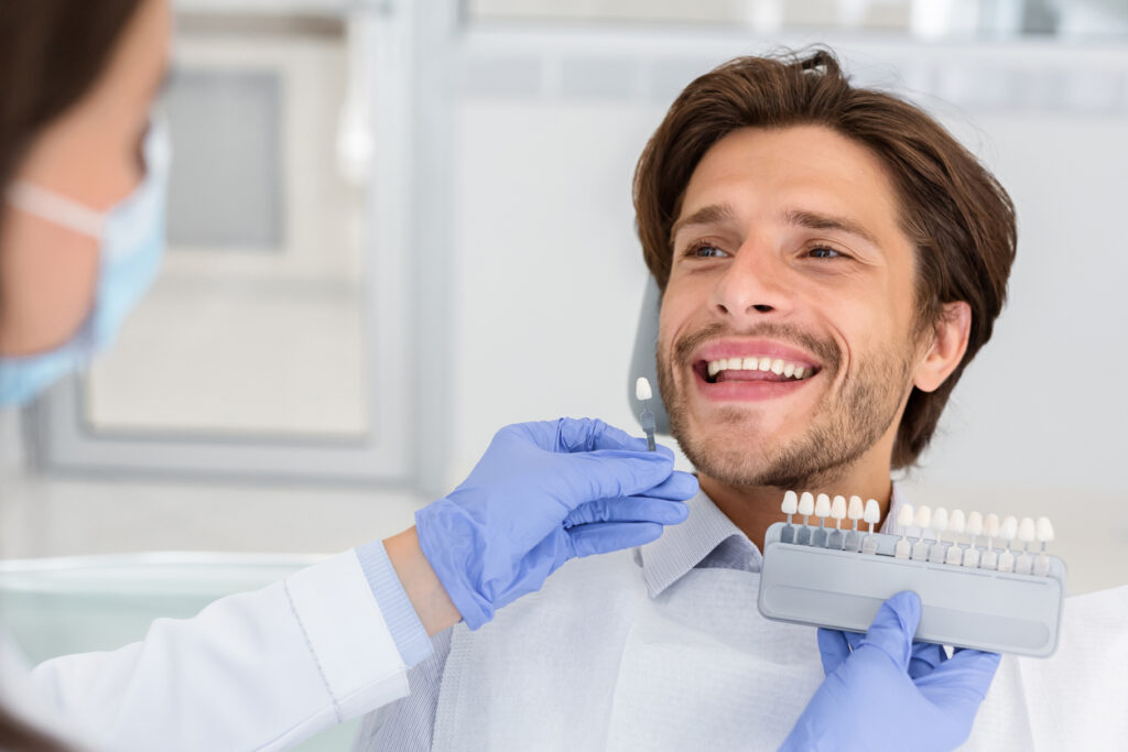patient choosing a tooth shade for an implant