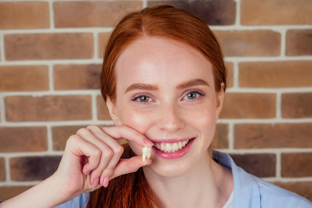 Patient holding the wisdom tooth that was removed