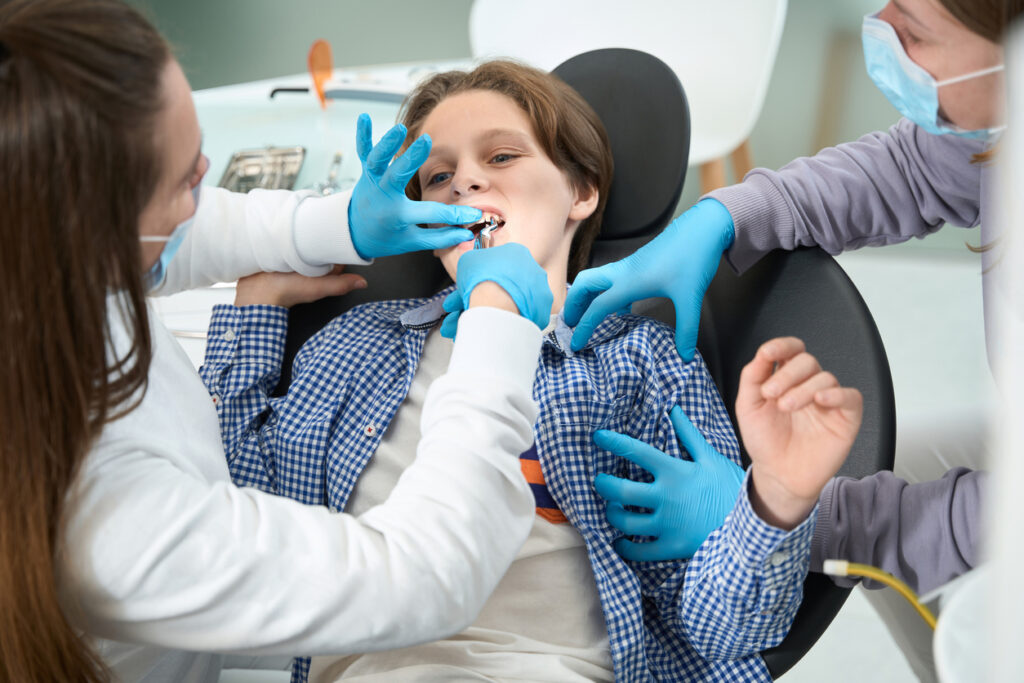 Dental patient having a tooth extracted with a special dental tool