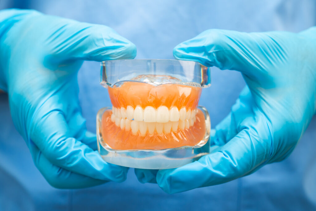 Dentist holding a set of dentures